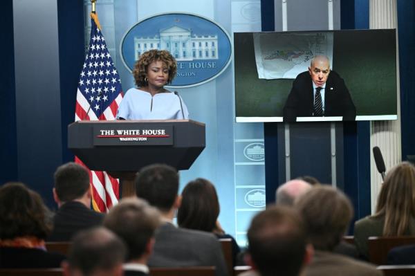White House Press Secretary Karine Jean-Pierre listens to US Homeland Security Secretary Alejandro Mayorkas speak via video link during the daily briefing in the Brady Briefing Room of the White House in Washington, DC, on October 10, 2024.